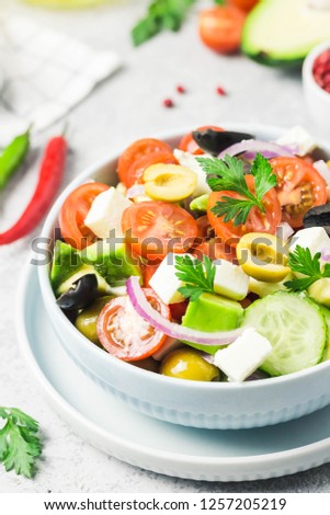 Avocado feta Greek salad in a bowl. Selective focus, space for text.