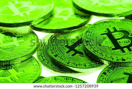 Bitcoins in Green indicating a positive price rise, Bull Run or Bull Market environment. Royalty-Free Stock Photo #1257208939