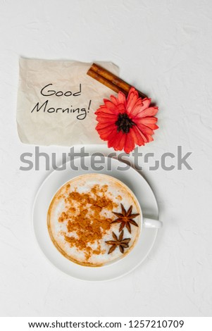 Coffee mug with red flower and notes Good morning on white table top, beautiful Breakfast, postcard, top view, flat lay