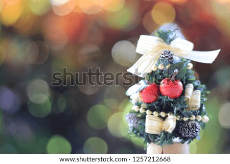 Close-up of small Christmas tree colorful lights are the background selective focus and shallow depth of field