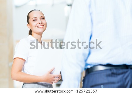 Business woman talking with a colleague in the office