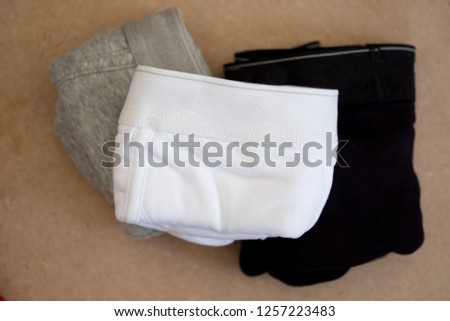 Group of male underwear on wooden background (Three men underwear)