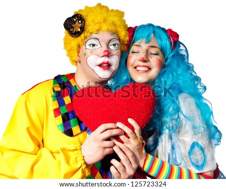 Clown giving his heart actress.Valentine day. Isolated on white