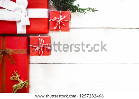 Gift box wrapped Christmas presents with bows and ribbons on white wood panel background, Christmas frame background and banner concept