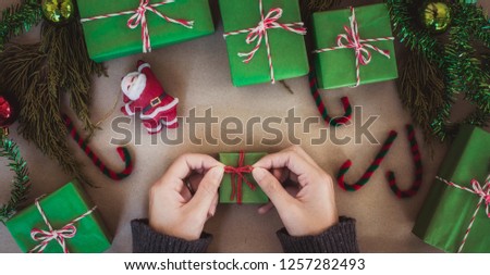 gift box with equipment and decorating items on table, preparing for celebrating Christmas holidays.