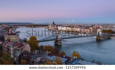 Panorama of the Hungarian Parliament, and the Chain bridge (Szechenyi Lanchid), over the River Danube, Budapest, Hungary, at sunset Royalty-Free Stock Photo #1257289996