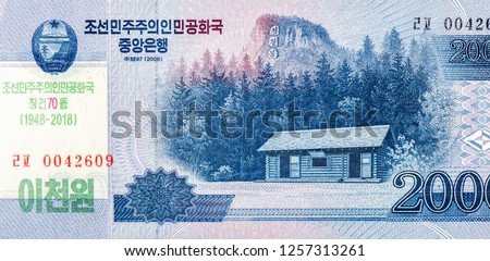 Log cabin on Baekdu Mountain, Jong Il Peak. Portrait from North Korea 2000 Won 2008  Banknotes. 