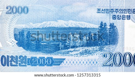 Heaven Lake (Cheonji), a caldera crater lake on Paektu Mountain. Portrait from North Korea 2000 Won 2008  Banknotes. An Old paper banknote, vintage retro. Famous ancient Banknotes. Collection.