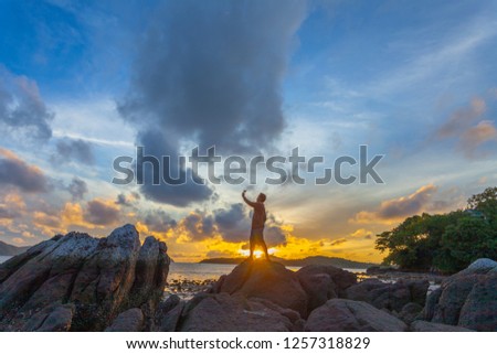 sunrise above the sea one man selfie on the rock 