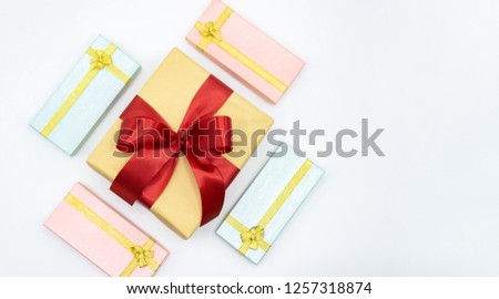 Christmas and New Year's Day , red ribbon gift box with pink and blue gift box top view on white background isolated 