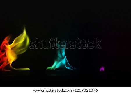 Abstract colorful smoke on black background, fire design - Image