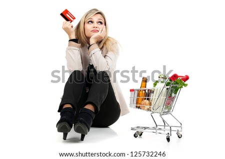 Woman with shopping cart and credit card isolated in white