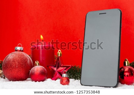 View of a Blank mock up smartphone on a red and white christmas decoration composition