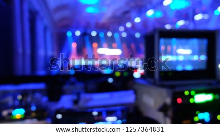 Blurred equipment for live streaming production with blue light background inside the hall and bokeh effect.  