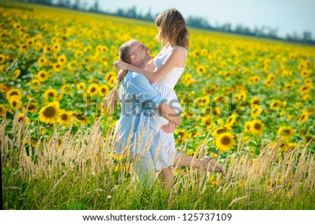 loving young couple in a field of sunflowers