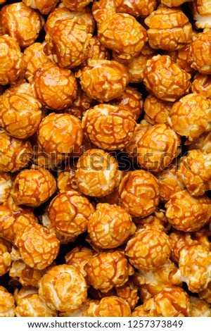 sweet Caramel Cream popcorn on the black background. Close-up picture, macro details