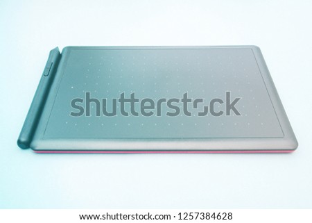 the simple graphic tablet close-up. Top view of graphic tablet on blue background