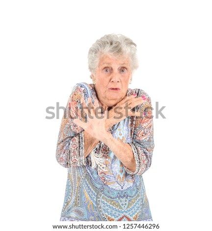 Scared old woman posing against a white background