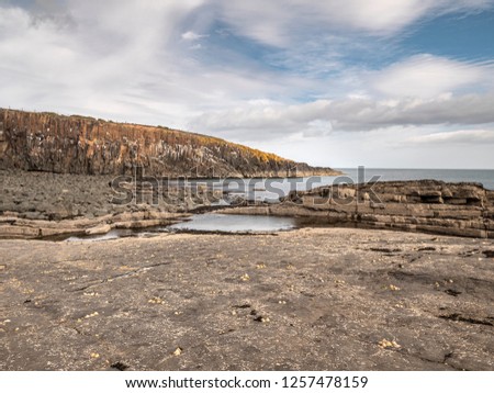 View Of Cullernose Point Near Howick, Northumberland Showing The Geology Of The Whin Sill Royalty-Free Stock Photo #1257478159