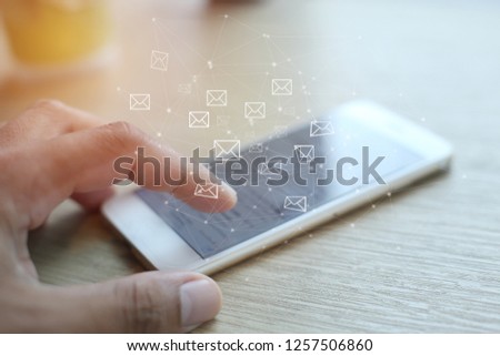 Business man hand using smartphone on mobile phone with email icon, concept