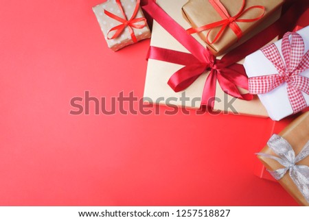 Many presents in boxes tied up with silky shiny ribbons on vibrant background. Preparation for holidays and celebration concept.