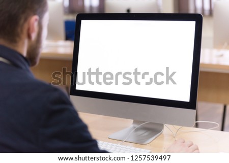 Young male Businessman working on modern computer. Businessman using innovative technologies. Businessman working on computer, software developing with modern tech on virtual screen. Royalty-Free Stock Photo #1257539497