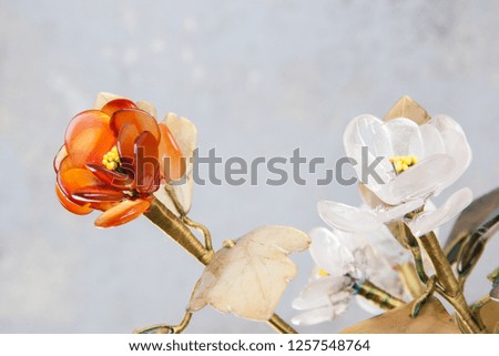 Vintage glass flowers on concrete background. Copy space for text.