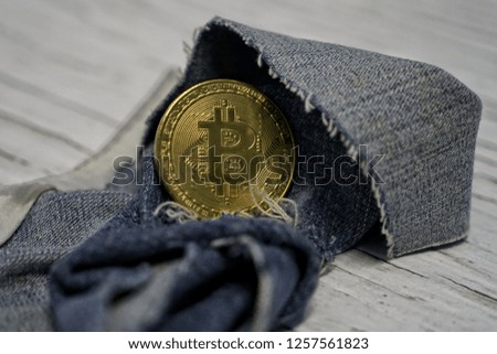 Golden bitcoins on the jeans pants. Making online money concept. How to make money conceptual image, Subject of Finance and Economy. 