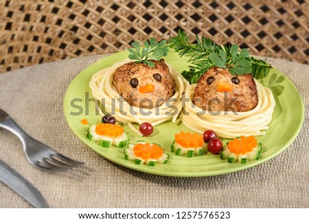 Children's menu- fried cutlets in the form of birds with cucumber and carrot flowers.