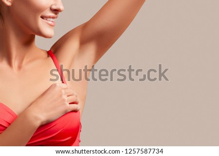 Armpit epilation, lacer hair removal. Young woman holding her arms up and showing clean underarms, depilation, smooth skin. underarm odorless and sweat. Beauty portrait model after hair removal.    