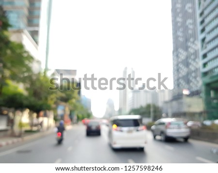 Blurred cityscape of busy road in the morning from motorcycle view. Bangkok CBD area or sathorn road from bike commuter perspective. Local, worker and lifestyle concept with copy space.