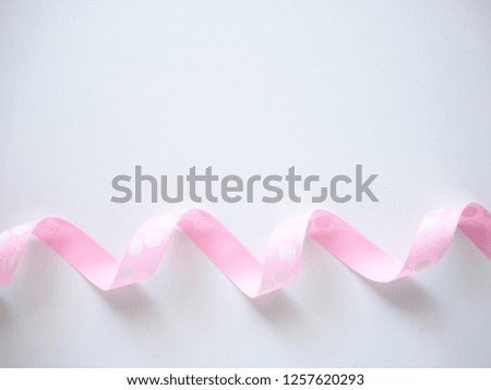 Pink curly ribbon on a  white background. flat lay photo copy space
