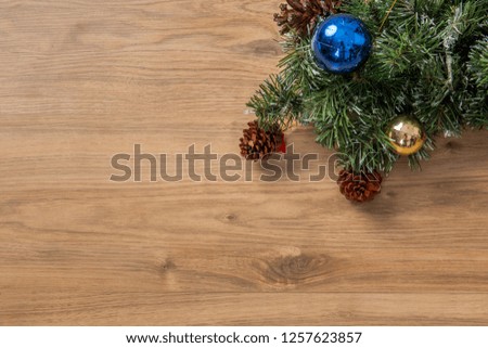 Christmas with pine trees, pine cones and sparkling decorations on a dark wooden table