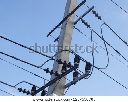 High-voltage wires on poles, high voltage lines and three-phase power lines stretched across the bonded porcelain insulators on poles.selective focus