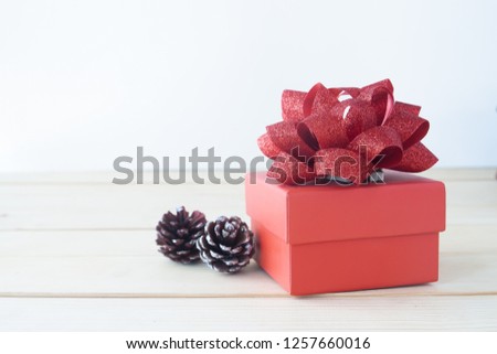 Beautiful red gift box on wooden table, Holiday gift, Valentine's Day concept