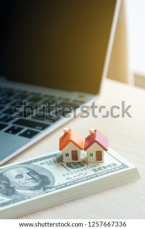 Real estate business concept, dollar banknote with miniature house mortgage, modern online marketing in real estate business.