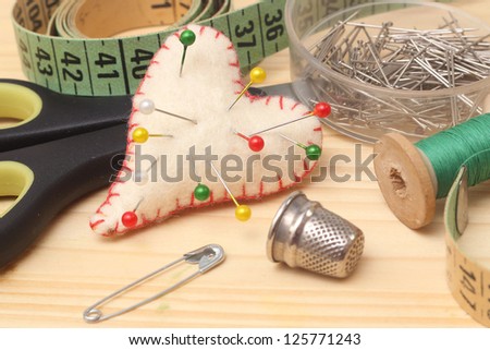tools for needlework, thread, scissors and tape measure