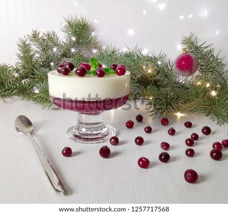 Panna Cotta, cranberries. New Year's (Christmas) dessert for breakfast. Panna Cotta or Cheesecake in a Glass with Cranberry Jam and Cranberries. Proper nutrition. Selective focus.