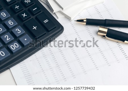 Business still life with calculator on table in office.