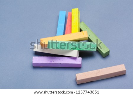 pile of multi color chalk on blue background