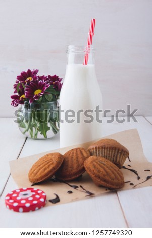 A delicious breakfast. Milk with cakes on a white table