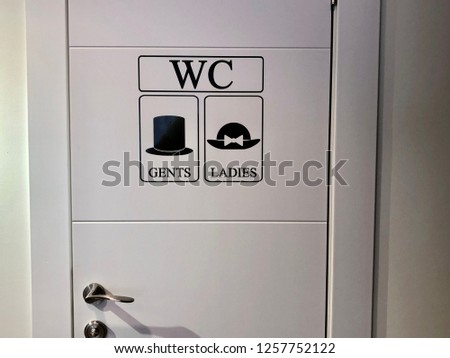 toilet door with a sign toilet inscriptions and symbols of male and female
