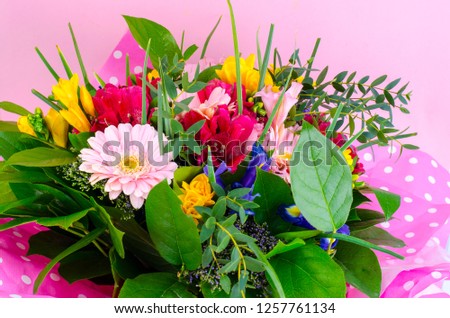 Beautiful bouquet of flowers on pink background. Studio Photo