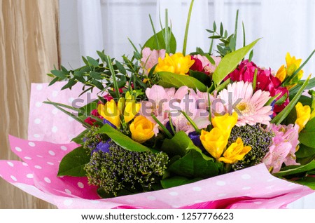 Bouquet of flowers in front of window. Studio Photo