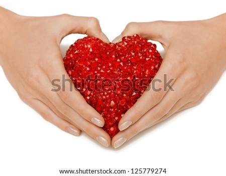 bright closeup picture of woman hands holding heart