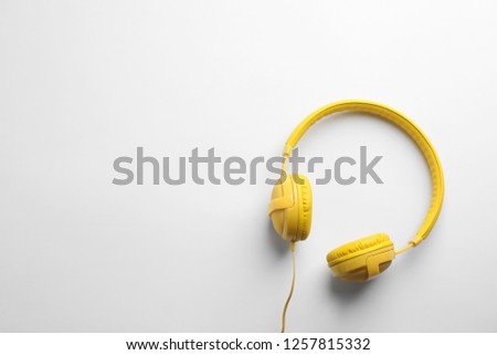 Stylish modern headphones with earmuffs on white background, top view. Space for text