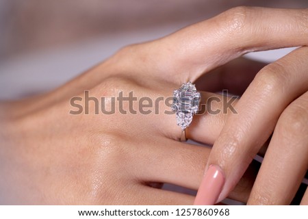 Diamond engagement ring on hand  Royalty-Free Stock Photo #1257860968