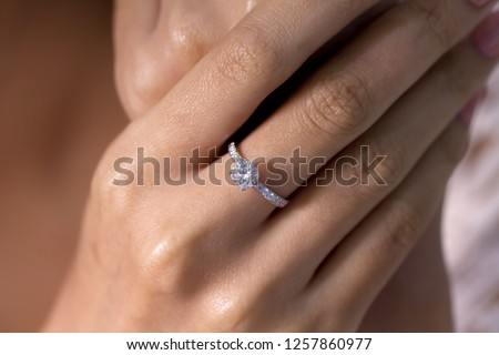 Diamond engagement ring on hand  Royalty-Free Stock Photo #1257860977