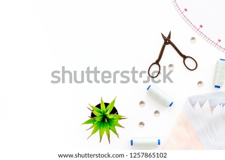 Tailor shop with thread, scissors, fabric. Sewing as hobby. White background top view mockup