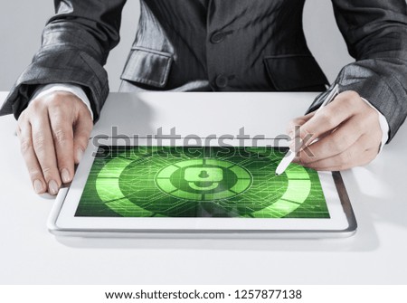 Close up of businesswoman sitting at atble and working on tablet pc